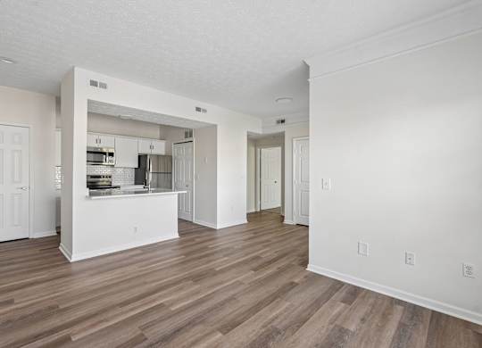 A kitchen with white cabinets and a white island with a sink.