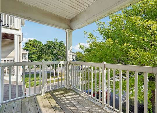 A white railing on a wooden deck.