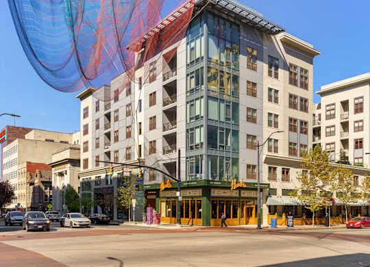 A large building with a blue and red net hanging in front of it.