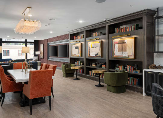 a dining room with a table and chairs and a television at The Madison, Columbus, 43215