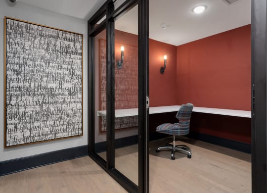 a conference room with a chair and a painting on the wall at The Madison, Columbus, Ohio