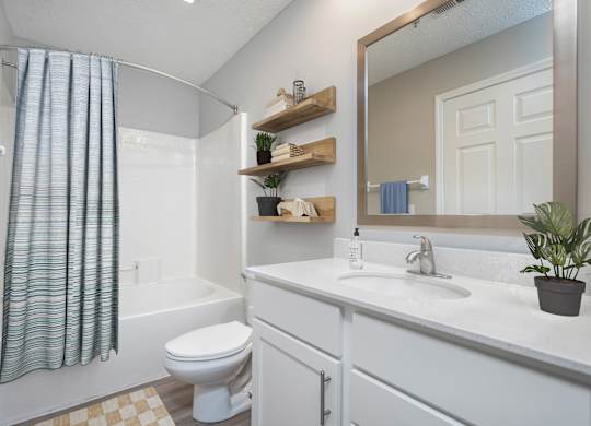 A white bathroom with a toilet, sink, and shower. at The Orchard, Dublin