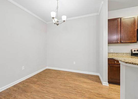 A room with wooden flooring and a chandelier.