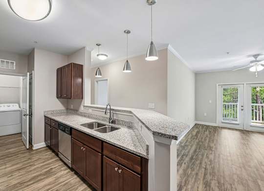 A kitchen with wooden cabinets and a granite countertop.