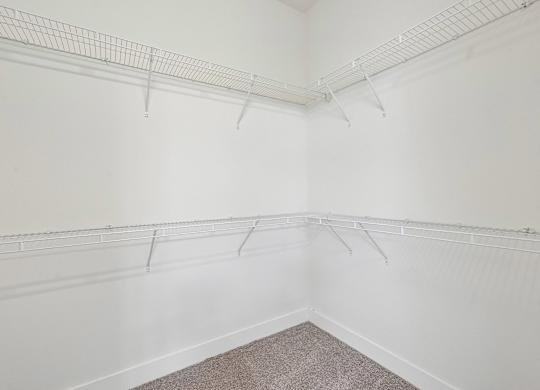 Empty room with white walls and a carpeted floor.