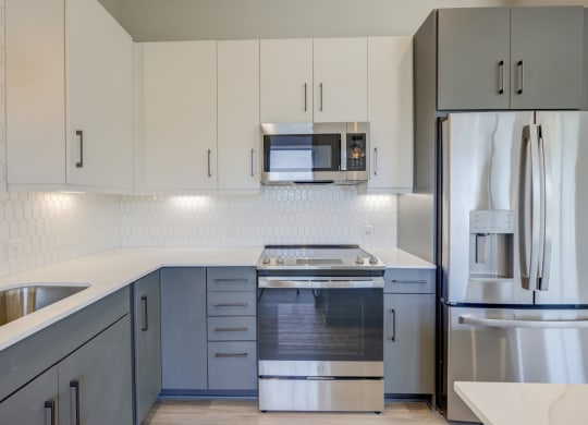 Modern Kitchen With Stainless Steel Appliances And Double Door Refrigerators at The Walker, Cary, NC