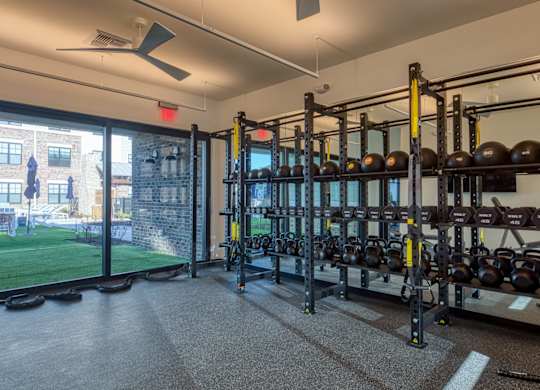 A gym with a view of a cityscape outside the window.
