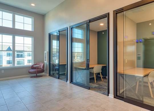A room with glass doors and a table and chairs inside.