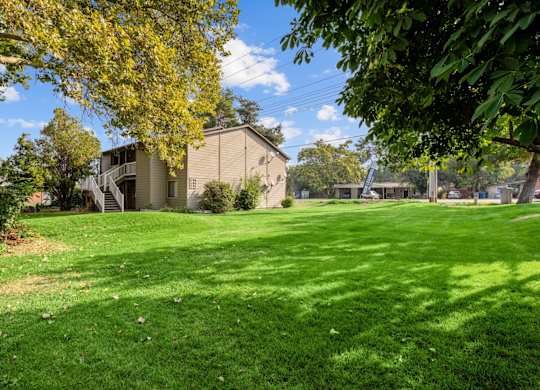 A green lawn in front of a building.
