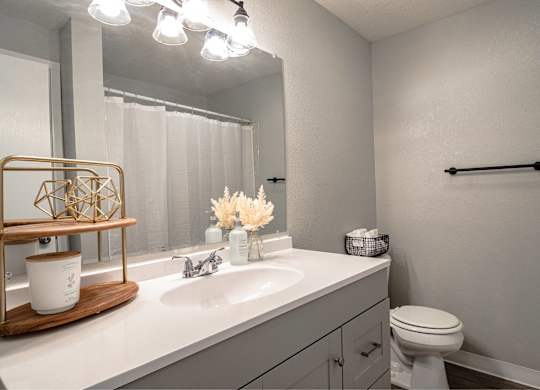A bathroom with a white toilet and a white sink.