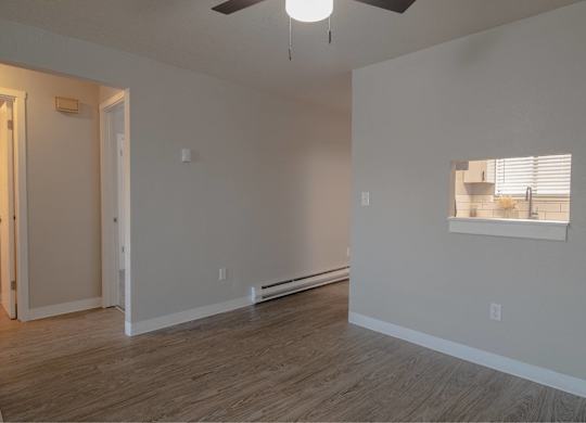 A room with a window and a ceiling fan.