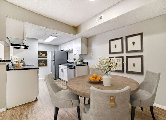 Dining room with round table and gallery wall at Peaks at Universal City Apartments, Universal City, 78148