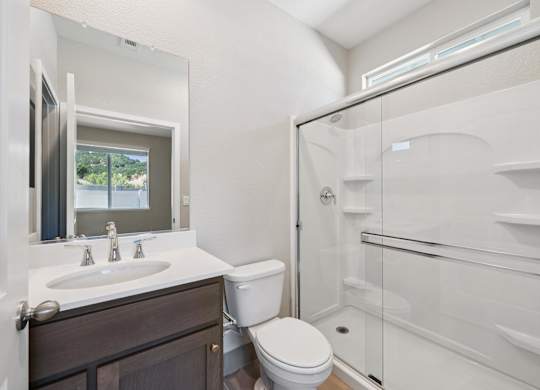 A White Bathroom with a Shower at Montessa Apartments, California, 95687