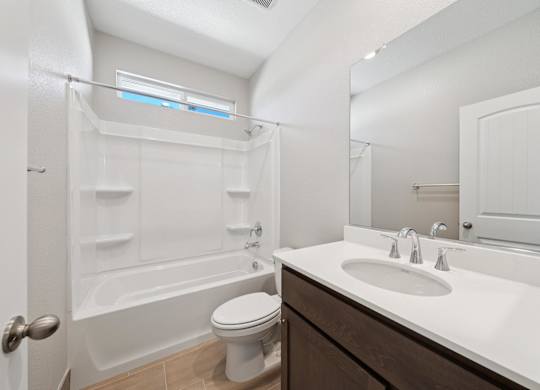 A White Bathroom with a Toilet at Montessa Apartments, Vacaville, CA, 95687