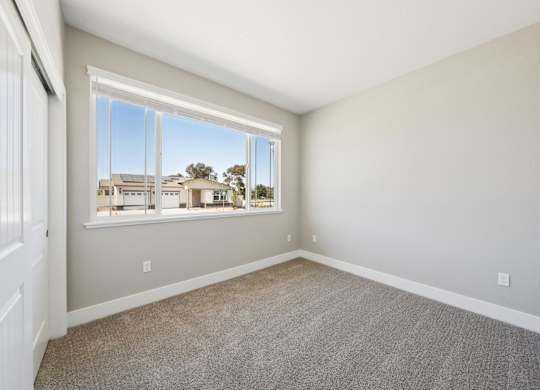 A Room with a Large Window at Montessa Apartments, California
