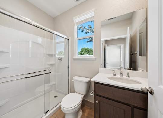 A Bathroom with a Mirror at Montessa Apartments, Vacaville