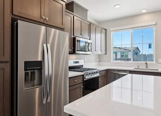 A Kitchen with a Window at Montessa Apartments, California