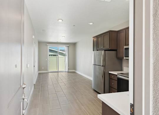 A Long Hallway with a Kitchen area at the end at Montessa Apartments, Vacaville