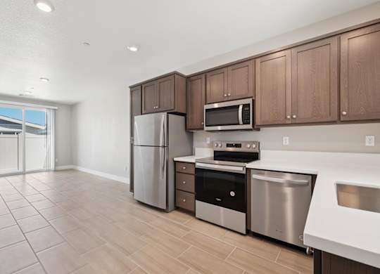 A Kitchen With Stainless Steel Appliances at Montessa Apartments, California