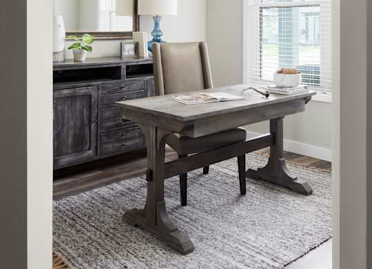 A dining room with a wooden table and chairs.