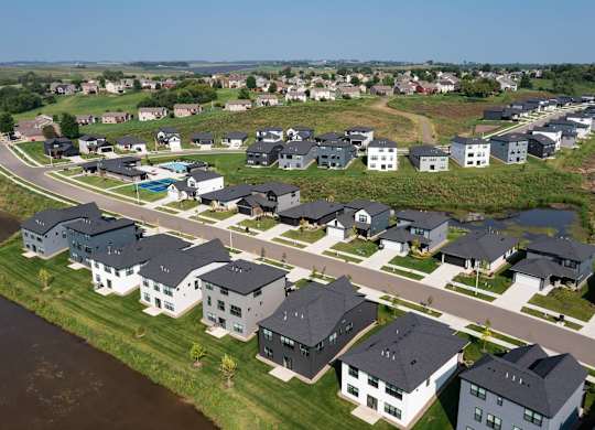 A row of houses with a body of water in front of them.