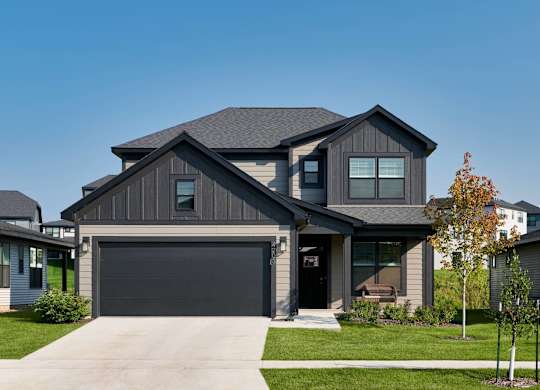 A modern house with a grey garage door.