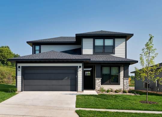 A modern house with a grey garage door.