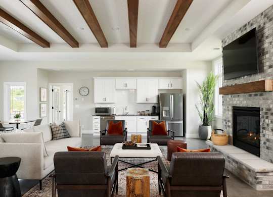 A modern living room with a fireplace and a dining area.