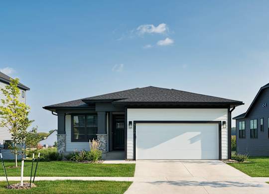 A modern house with a garage door is shown.