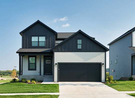 A modern house with a black garage door.