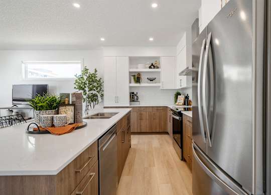 A modern kitchen with a large stainless steel refrigerator.