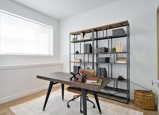 A room with a desk and a shelf with various items on it.