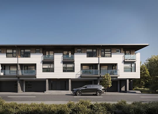A modern building with a car parked in front.