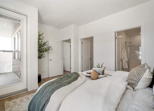 A bedroom with a large bed and a window.