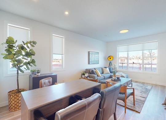 A living room with a dining table and chairs.