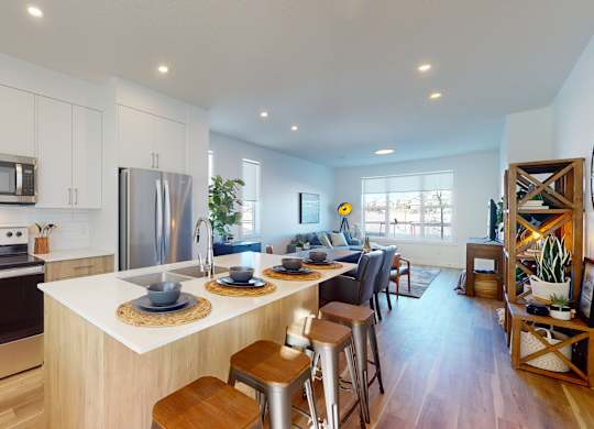 A modern kitchen with stainless steel appliances and wooden cabinets.