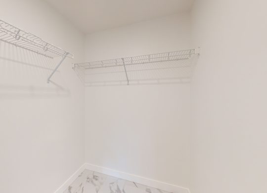A white room with a metal rack on the wall.