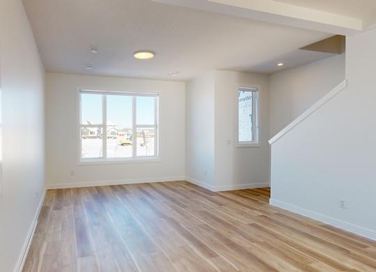 A room with wooden floors and white walls.