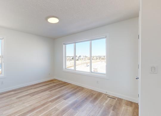 A room with a window overlooking a snowy landscape.