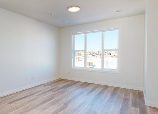 A room with a window overlooking a cityscape.