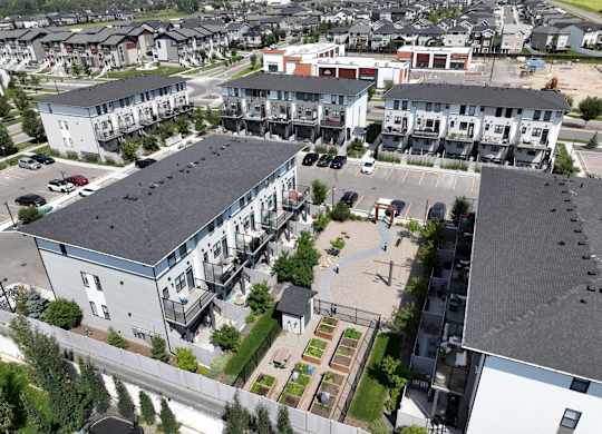 A view of a residential area with apartment buildings and a parking lot.