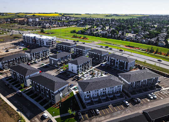 A large, modern building complex with multiple buildings and parking lots.