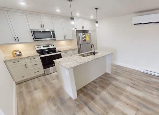 A kitchen with a stove top oven and a microwave.