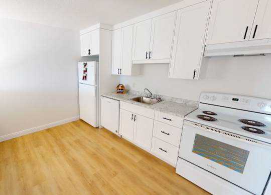 A kitchen with white appliances and wooden floors.