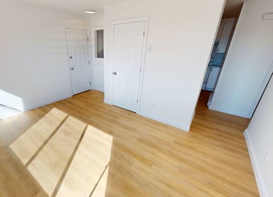 A room with wooden floors and white walls.