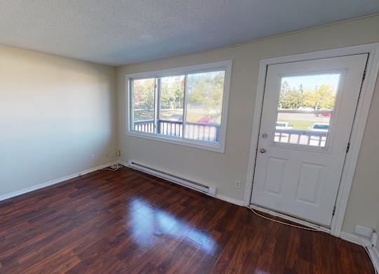 A room with wooden floors and white walls.