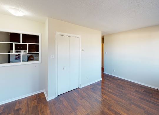 A room with a white door and a window with a white frame.