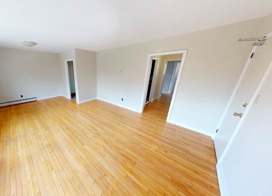 A room with wooden floors and white walls.