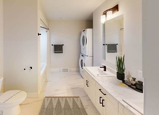 A white bathroom with a toilet, sink, and mirror.