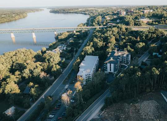 A river flows through a city with a bridge crossing over it.
